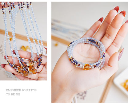 Multicolored beaded bracelets on a hand with a blurred background