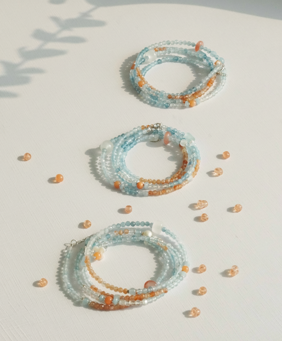 Set of beaded bracelets on a light surface with a soft shadow