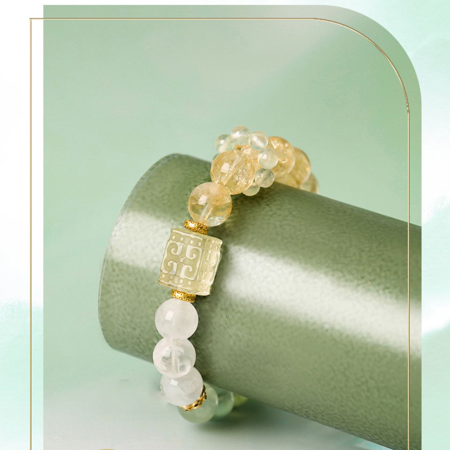 Bracelet with gold and white beads on a green background