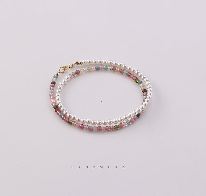 Handmade bracelet with multicolored beads on a light background