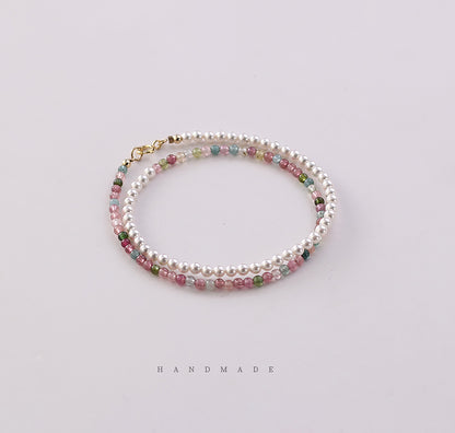 Handmade bracelet with multicolored beads on a light background