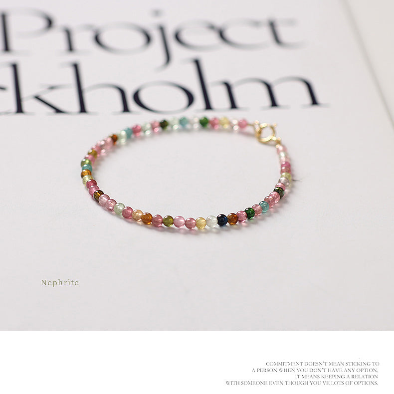 Multicolored beaded bracelet on a magazine with 'Project Stockholm' text