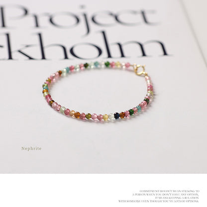 Multicolored beaded bracelet on a magazine with 'Project Stockholm' text