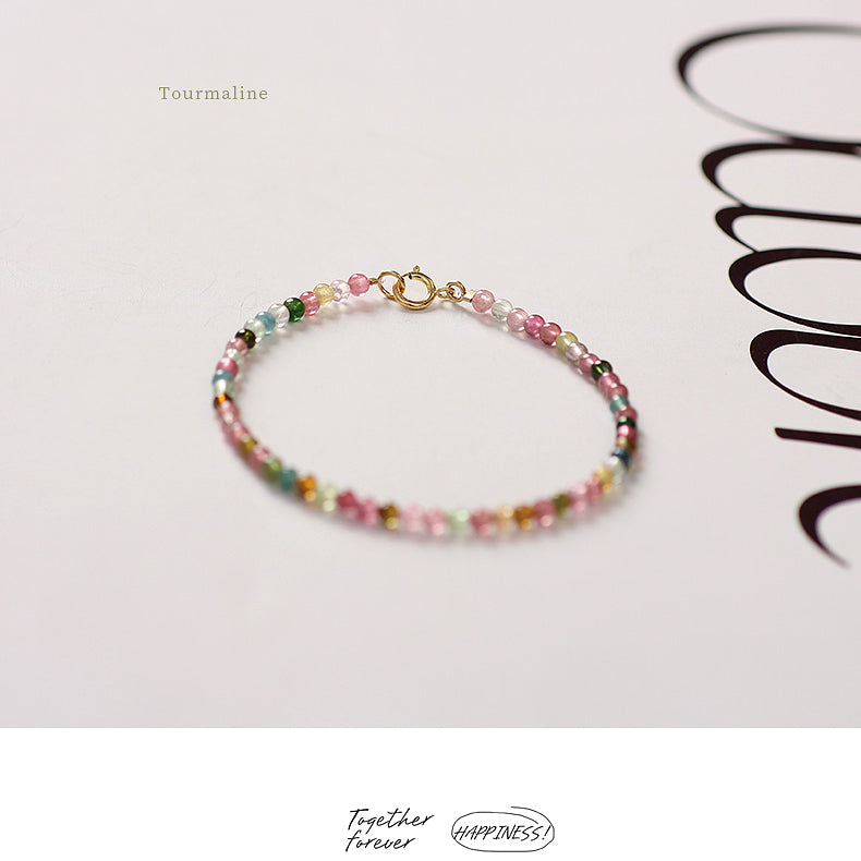 Multicolored beaded bracelet on a white background with 'Happiness' branding.