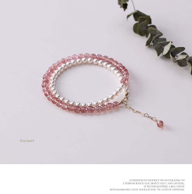 Beaded bracelet with pink and white beads on a light background.