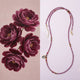 Beaded necklace with floral design on a pink background