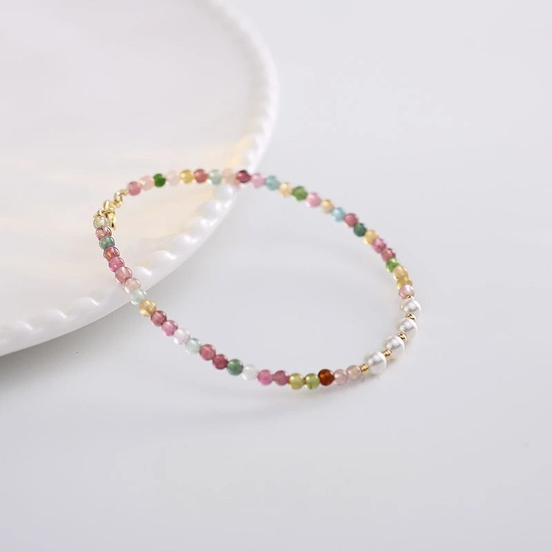 Multicolored beaded bracelet on a white ceramic dish