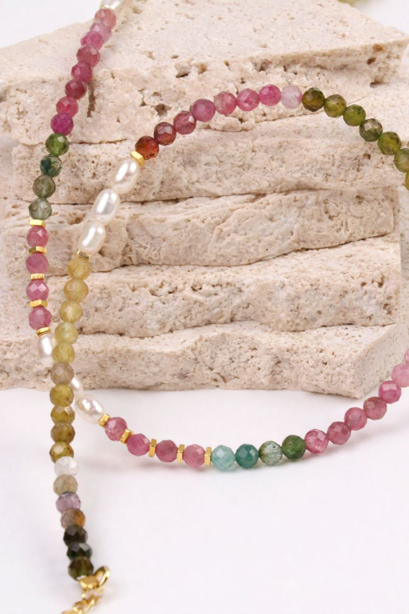 Multicolored beaded necklace on a textured surface