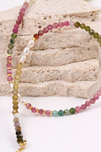 Multicolored beaded necklace on a textured surface